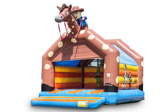 Grande château gonflable avec toit sur le thème du cow-boy à acheter pour les enfants. Disponible chez JB Gonflables France en ligne